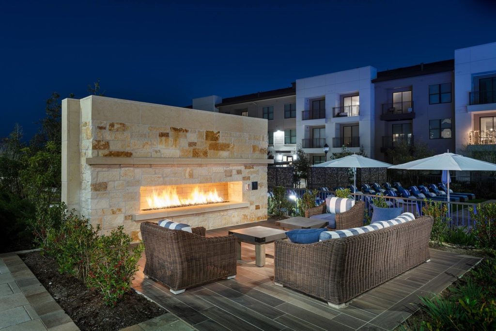 A fireplace by the pool at the Windsor Oak Hill Apartments.
